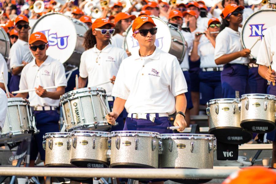 Sophomore+Kevin+Hendricks+plays+tenor+drums+in+the+stands+of+the+NSU+vs.+Louisiana+Tech+football+game+Sept.+2.+Photo+credit%3A+Justin+Burr