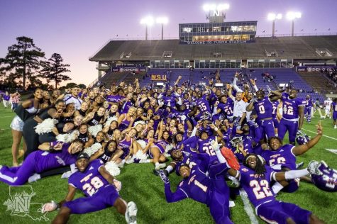 Demon Football holding the NSU trophy after defeating Nicholls.