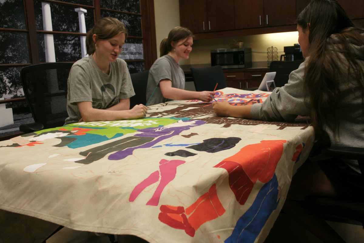 (L-R) Alexis Callihan, Kay Callihan and Logan Falgout work on the banner for NSU Ambassadors.
