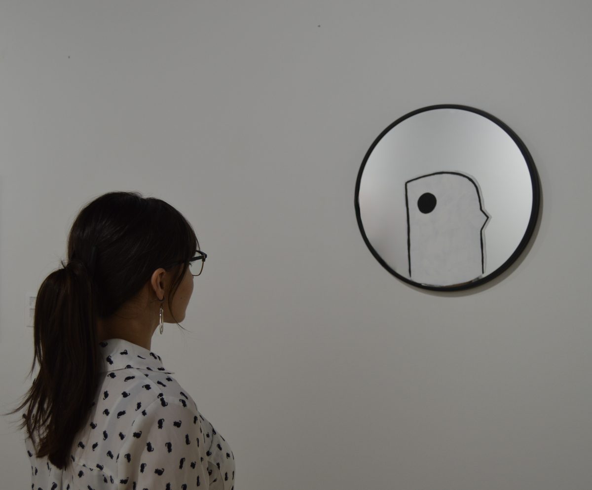 Madeline Romero stares at her work “Mirror (The Little Bird Inside You).”