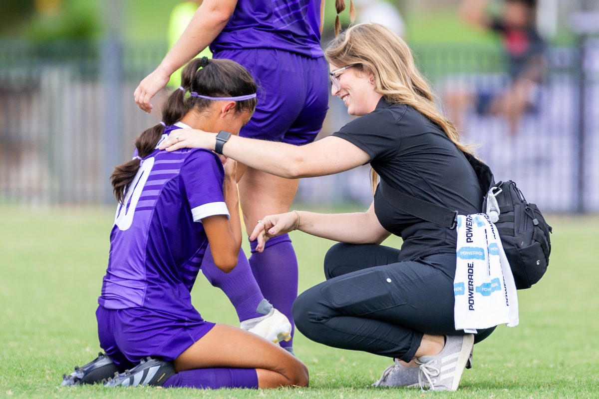 NSU athletic trainer Kristina Overholt tends to a Lady Demons soccer player during the match against Mississippi Valley State University.