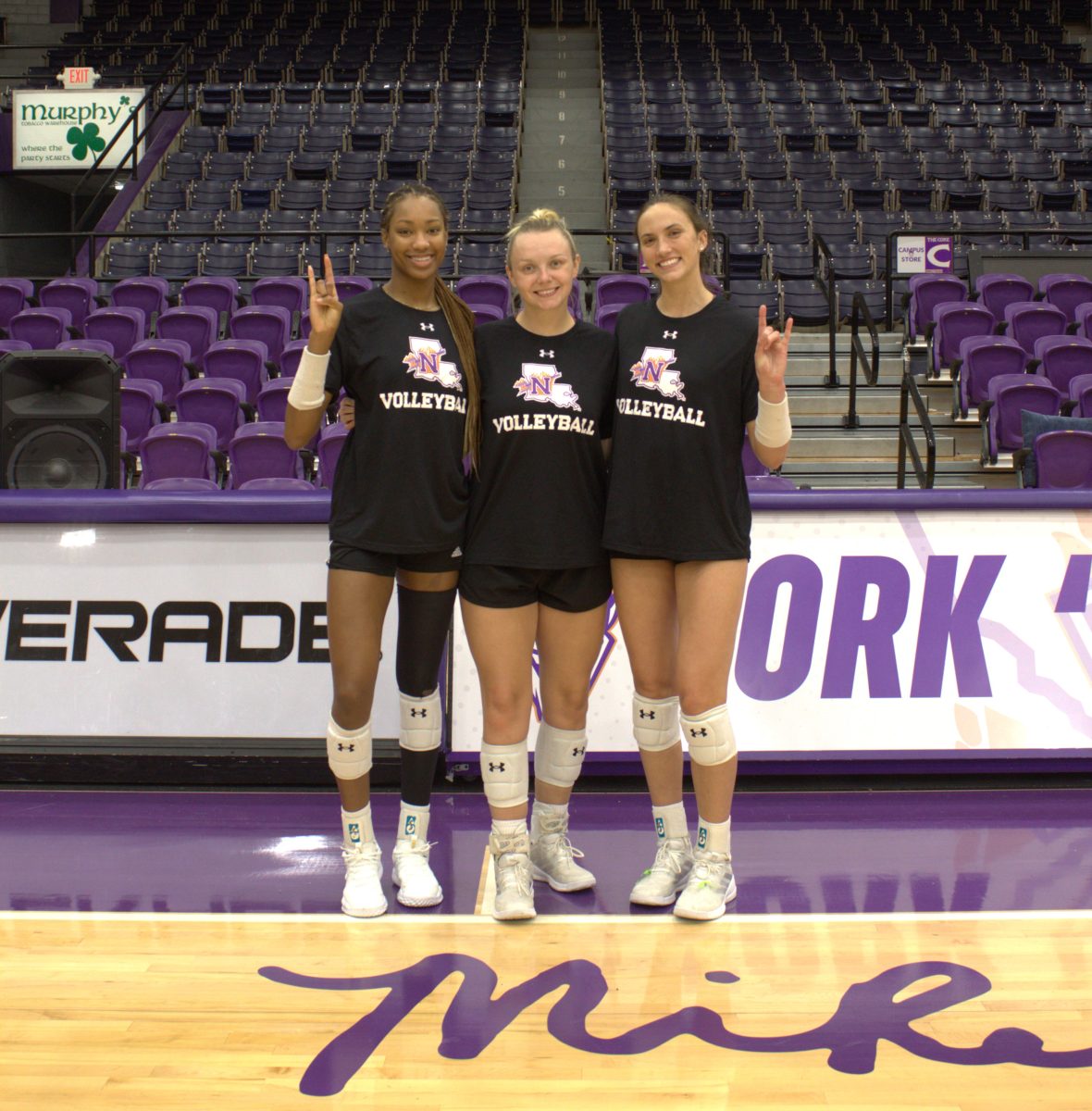 Volleyball players Samaya Wesson (left), Ashlyn Svoboda and Reaghan Thompson (right) discuss the upcoming Battle for the Boot. 