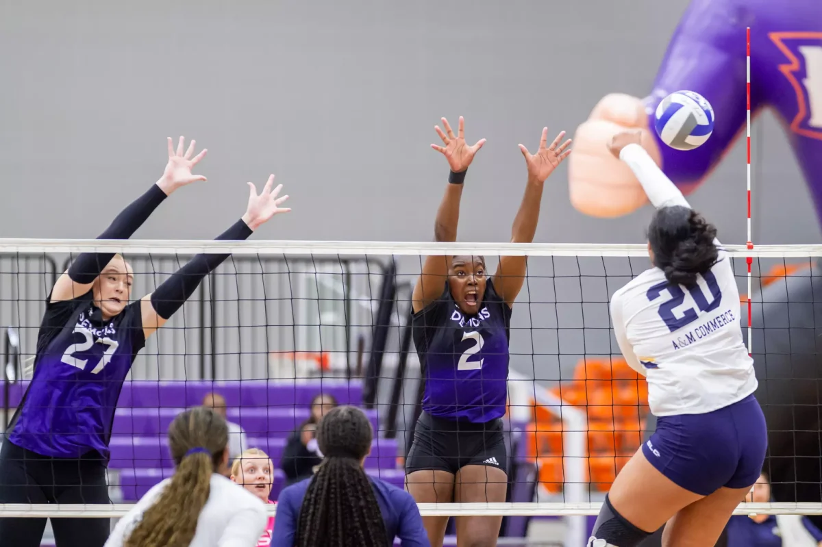 Madisynne McQueen, junior outside hitter, blocks against Texas A&M University-Commerce during the 2023 season. 