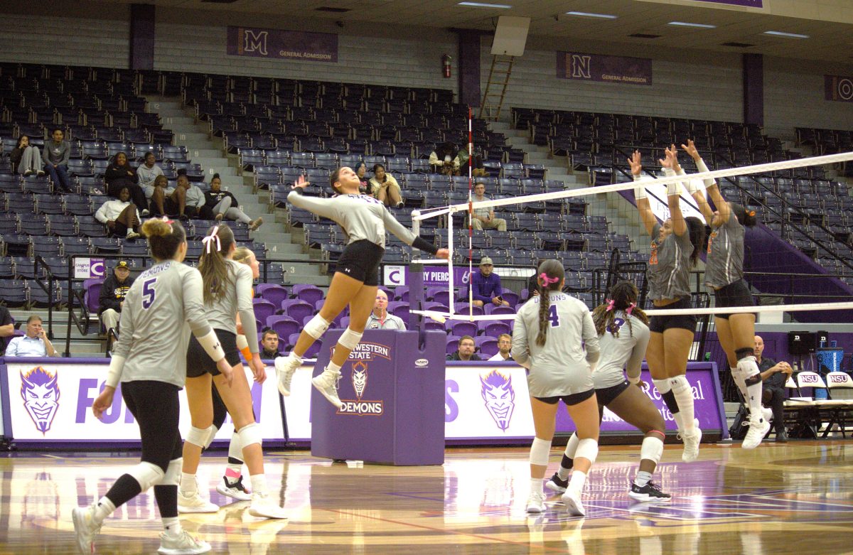 Teresa Garza, senior sports and recreation management major and outside hitter, hits against the University of Texas Rio Grande Valley Vaqueros in match on Friday in Prather Coliseum. 