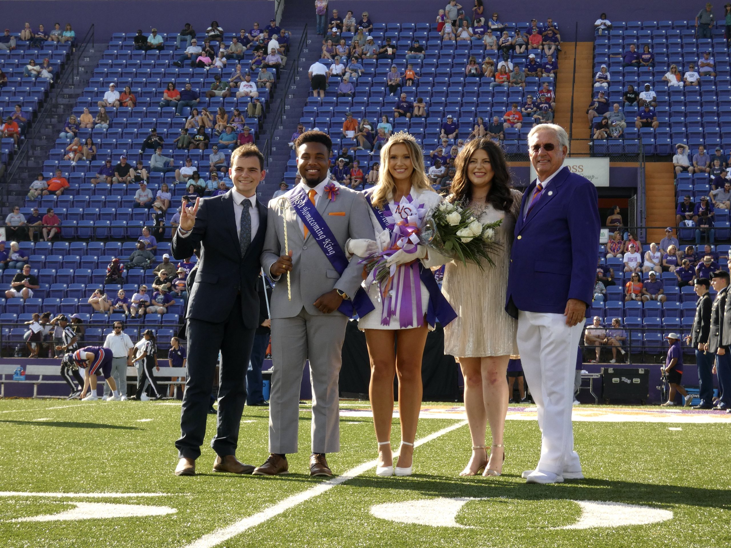 (L-R) 2023 Homecoming King Zach Cooper passes his crown to Christian James, and Kaley Koss receives her Homecoming Queen crown from last year’s queen Zoe Johnson with the help of NSU President James Genovese. 