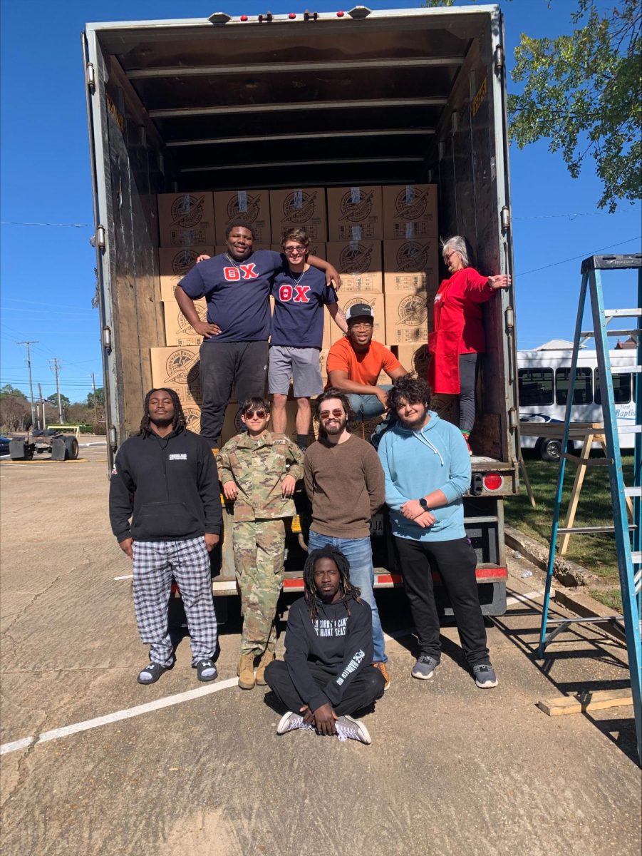 Theta Chi members help First Baptist Church pack delivery truck. 